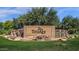 Beautiful Trilogy community entrance sign with stone accents, a waterfall feature, and lush green landscaping at 5024 S Citrus Ct, Gilbert, AZ 85298