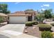 Charming single-story home with a well-manicured front yard and a two-car garage at 5024 S Citrus Ct, Gilbert, AZ 85298