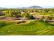 Beautiful green golf course with a sand trap and mountain views in this active adult community at 5024 S Citrus Ct, Gilbert, AZ 85298
