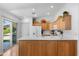 Well-lit kitchen featuring sleek countertops, wood cabinets, and easy access to the backyard at 5024 S Citrus Ct, Gilbert, AZ 85298