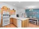 Cozy kitchen with dining space, white appliances, a center island, and appealing decor at 5024 S Citrus Ct, Gilbert, AZ 85298