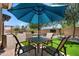 Inviting patio features an umbrella table set and artificial grass; great for outdoor relaxation and entertaining at 5024 S Citrus Ct, Gilbert, AZ 85298