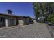 Low maintenance backyard with stone landscaping, storage shed, and mature trees at 5148 E Edgewood Cir, Mesa, AZ 85206