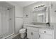 Bathroom featuring white vanity with granite countertop, a large mirror, and a tiled shower stall at 5148 E Edgewood Cir, Mesa, AZ 85206