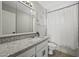 Bathroom featuring white vanity with granite countertop, large mirror, and shower with tub at 5148 E Edgewood Cir, Mesa, AZ 85206