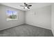 Bedroom featuring gray carpet, ceiling fan, and a window with a view to the street outside at 5148 E Edgewood Cir, Mesa, AZ 85206