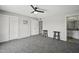 Spacious bedroom featuring gray carpet, ceiling fan, and closet with a view into the ensuite bathroom at 5148 E Edgewood Cir, Mesa, AZ 85206