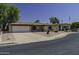 Charming home featuring a well-manicured front yard, covered entry, and attached two-car garage at 5148 E Edgewood Cir, Mesa, AZ 85206