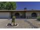 Front exterior of the home, featuring a desert landscape, covered entry, and brick accents at 5148 E Edgewood Cir, Mesa, AZ 85206