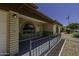 Inviting front porch with decorative brickwork, metal railing, and arched windows at 5148 E Edgewood Cir, Mesa, AZ 85206