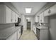 Bright kitchen with white cabinets, granite countertops, stainless steel appliances, and wood-look flooring at 5148 E Edgewood Cir, Mesa, AZ 85206