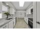 Open kitchen design with white cabinets, granite countertops, stainless steel appliances, and modern flooring at 5148 E Edgewood Cir, Mesa, AZ 85206