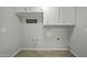 Bright laundry room with cabinets and modern connections for washer and dryer at 5148 E Edgewood Cir, Mesa, AZ 85206