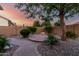 Paver pathway and desert landscaping in backyard with mature tree at 5607 W Alyssa Ln, Phoenix, AZ 85083