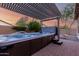 Backyard oasis with hot tub featuring a pergola and decorative water feature at 5607 W Alyssa Ln, Phoenix, AZ 85083