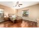Cozy bedroom with hardwood floors, ceiling fan, and bright natural light at 5607 W Alyssa Ln, Phoenix, AZ 85083