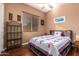 Cozy bedroom with star patterned quilt, ceiling fan, and window blinds at 5607 W Alyssa Ln, Phoenix, AZ 85083