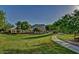 Scenic community park with lush green grass and walking path under shade trees at 5607 W Alyssa Ln, Phoenix, AZ 85083