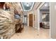 Entryway with tile flooring, stone accent wall, and open access to living spaces at 5607 W Alyssa Ln, Phoenix, AZ 85083