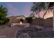 An outdoor fire pit surrounded by a semi-circular seating area sits on a brick patio with desert landscaping at 5607 W Alyssa Ln, Phoenix, AZ 85083