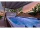 Backyard hot tub with pergola and water feature under a colorful sky at 5607 W Alyssa Ln, Phoenix, AZ 85083