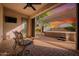 A covered patio with chairs leads to a hot tub in the backyard at 5607 W Alyssa Ln, Phoenix, AZ 85083