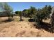 Backyard with sparse ground cover, trees, and block fence under a clear blue sky at 5634 W Puget Ave, Glendale, AZ 85302