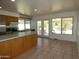 Bright kitchen with an island, modern appliances, wood cabinets, and access to the backyard at 5634 W Puget Ave, Glendale, AZ 85302