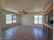 Spacious living room filled with natural light, tile flooring, and a ceiling fan at 5634 W Puget Ave, Glendale, AZ 85302