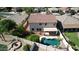 Aerial view of the backyard featuring a uniquely shaped private pool and covered patio at 6014 W Oberlin Way, Phoenix, AZ 85083