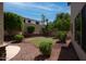 Expansive backyard featuring a grassy lawn area, mature trees, rock landscaping, and outdoor entertaining space at 6014 W Oberlin Way, Phoenix, AZ 85083