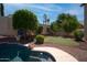 Lush backyard features manicured landscaping, a sparkling pool, and a privacy fence for outdoor enjoyment at 6014 W Oberlin Way, Phoenix, AZ 85083