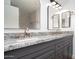 Bathroom featuring a granite double vanity with gold fixtures and a framed mirror at 6014 W Oberlin Way, Phoenix, AZ 85083