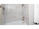 Bathroom with white marble tile surround, gold fixtures and a deep soaking tub at 6014 W Oberlin Way, Phoenix, AZ 85083
