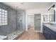 Beautiful bathroom with modern shower, glass, stone flooring, dual mirrors and countertop at 6014 W Oberlin Way, Phoenix, AZ 85083