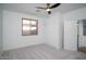 Bedroom featuring white walls, neutral carpet, window and sliding closet doors at 6014 W Oberlin Way, Phoenix, AZ 85083