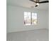 Light and airy bedroom with neutral carpet, ceiling fan, and view of neighborhood at 6014 W Oberlin Way, Phoenix, AZ 85083