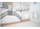 Grand entryway features a staircase with black railings, wood flooring, and soaring ceilings at 6014 W Oberlin Way, Phoenix, AZ 85083