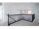 Bright hallway landing with neutral carpeting and a dark wood railing at 6014 W Oberlin Way, Phoenix, AZ 85083