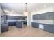 Spacious kitchen with gray cabinets, stainless appliances, island, and wood-look tile flooring at 6014 W Oberlin Way, Phoenix, AZ 85083
