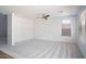 Spacious living room with neutral carpet, ceiling fan, and large window at 6014 W Oberlin Way, Phoenix, AZ 85083