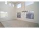 Open concept living room with tall windows, carpet, and modern chandelier at 6014 W Oberlin Way, Phoenix, AZ 85083