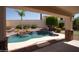 Backyard oasis with a sparkling pool, rock waterfall, desert landscaping, and covered patio for outdoor enjoyment at 6014 W Oberlin Way, Phoenix, AZ 85083