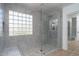 Modern bathroom with a glass-enclosed shower, stylish tiling, and natural light from the glass block window at 6014 W Oberlin Way, Phoenix, AZ 85083