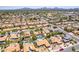 Expansive aerial view of a community, showcasing homes with red tile roofs, pools, desert landscaping and quiet streets at 6017 E Kathleen Rd, Scottsdale, AZ 85254