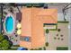 An aerial view features a tiled roof, pool with diving board, patio with umbrellas, and manicured desert landscaping at 6017 E Kathleen Rd, Scottsdale, AZ 85254