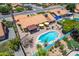 A backyard pool with diving board, patio, desert landscaping, and a view of the neighborhood in this aerial image at 6017 E Kathleen Rd, Scottsdale, AZ 85254