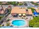 Aerial view showcasing a private backyard pool with a diving board and patio with yellow umbrellas at 6017 E Kathleen Rd, Scottsdale, AZ 85254