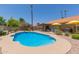 View of the kidney shaped pool with an outdoor living space including a covered patio at 6017 E Kathleen Rd, Scottsdale, AZ 85254