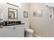 Stylish half bathroom with modern vanity, elegant mirror, and neutral decor at 6017 E Kathleen Rd, Scottsdale, AZ 85254
